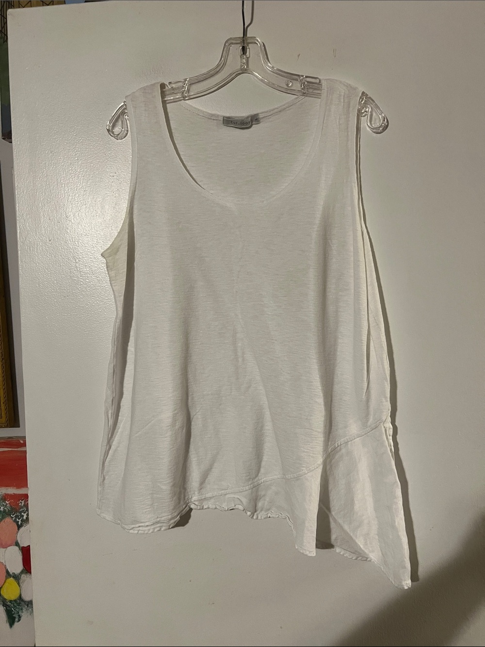 Cut loose cream sleeveless asymmetrical top